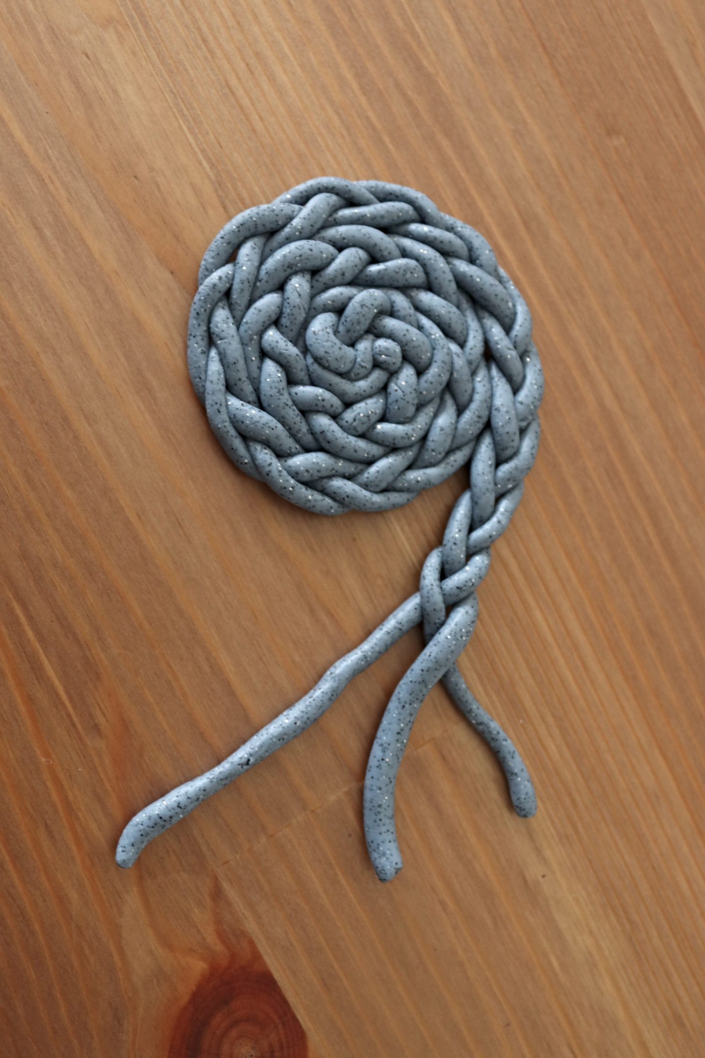 plaited clay strands in a coil