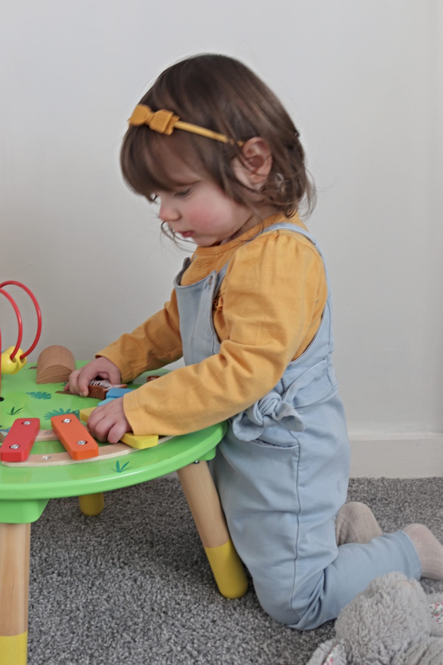 Noa in the blue dungarees and ochre coloured top